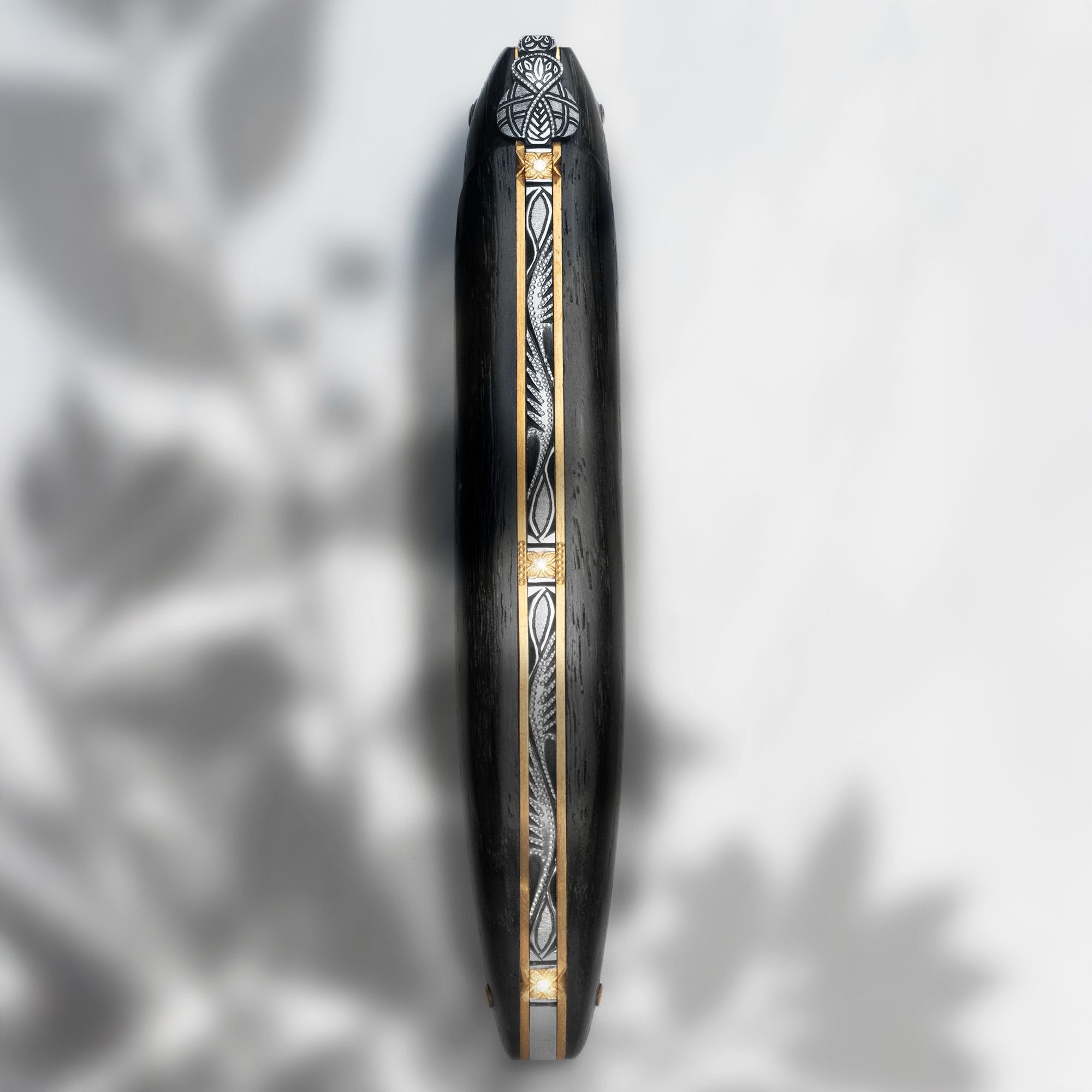 Side view of black ring with ornament